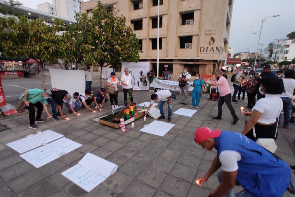 People gathered in a circle in memorial public action condemning the killing of social leaders in Barrancabermeja