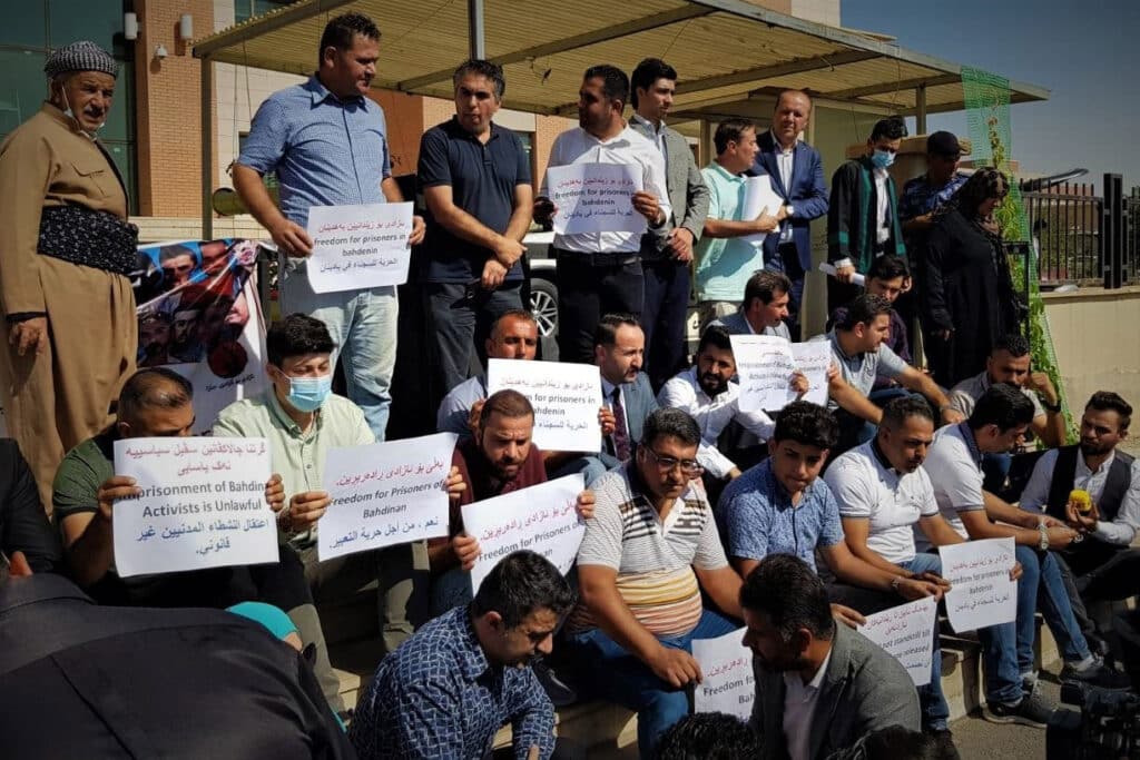 people at a protest holding sheets of paper with signs