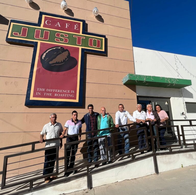 coffee farmers stand in front of Cafe Justo, a cooperative that has changed the course of migration