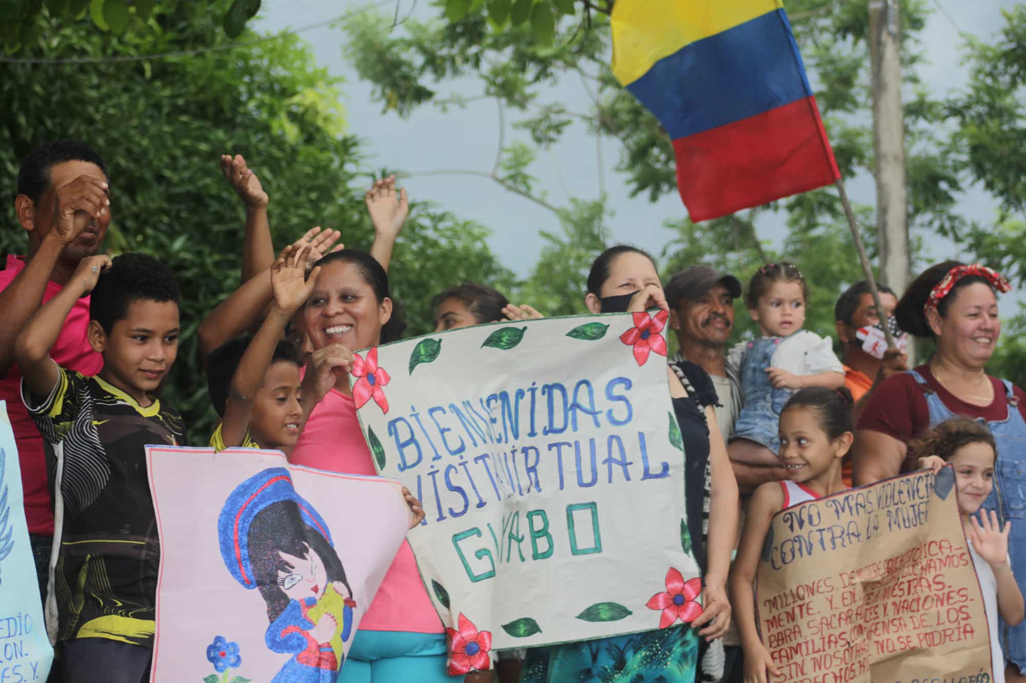 Group of people hold up a sign