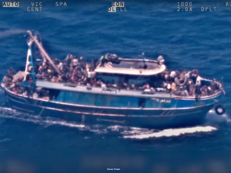 A surveillance photograph of a distressed boat