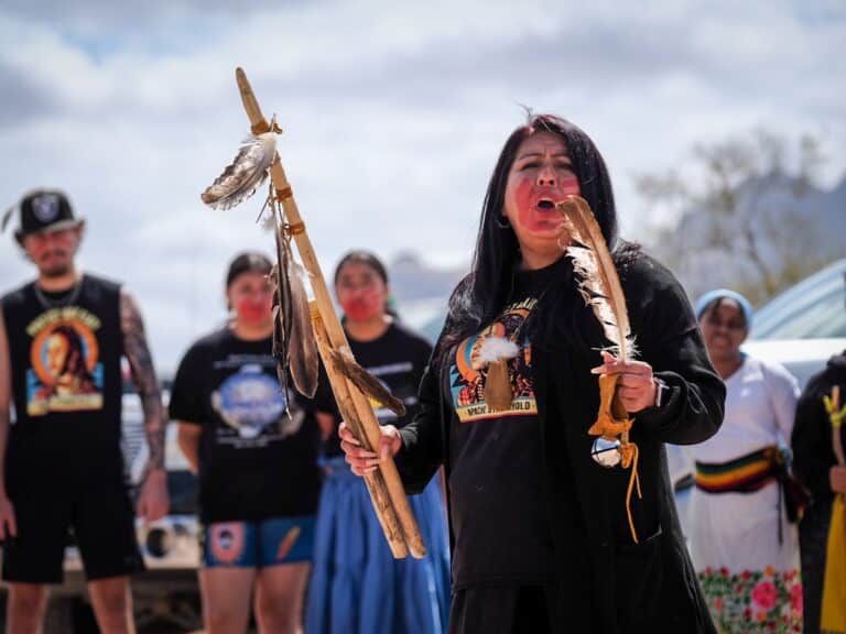 A woman speaks to a gathering