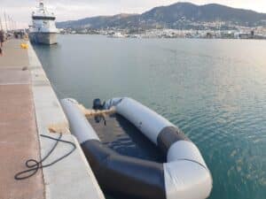 A shipwrecked dinghy docked in the port