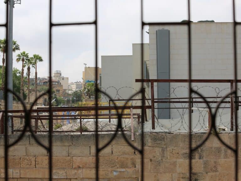 A cityscape seen through a fence