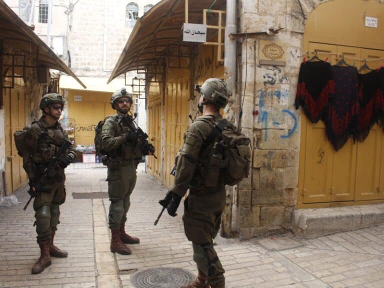 A group of Israeli soldiers guarding a street entrance