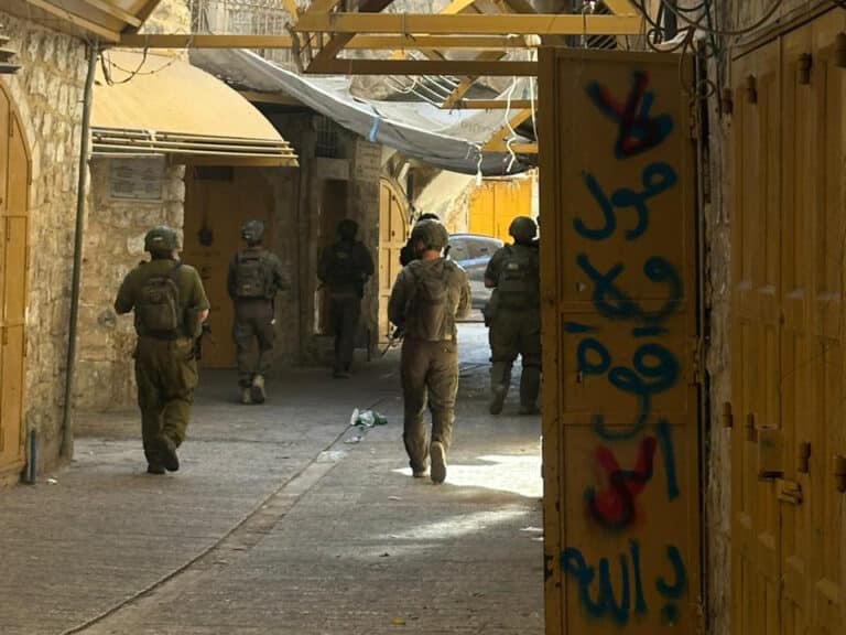 Israeli military walking down a street