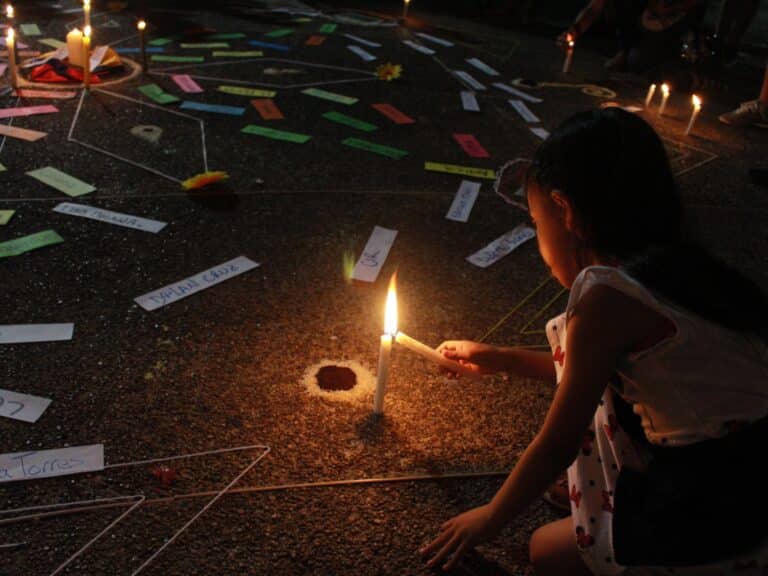 A girl lighting a candle