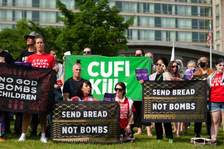 aa group gather holding banners at a protest against CUFI
