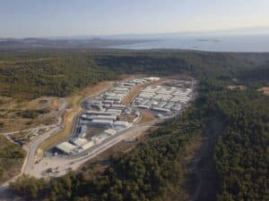 An aerial shot of a closed refugee centre, in the middle of a forest