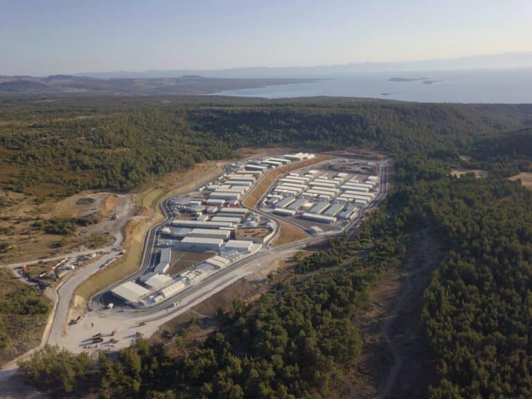 An aerial shot of a closed refugee centre, in the middle of a forest