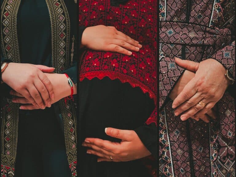 Palestinian women, some of them pregnant, hold their hands over their bellies
