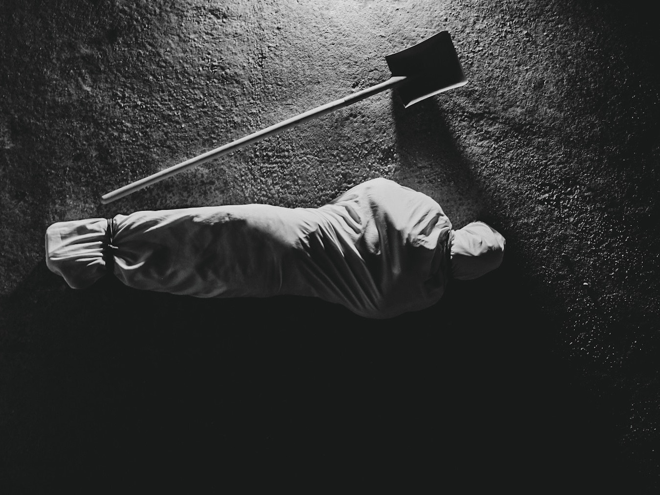 A person wrapped in a burial shroud