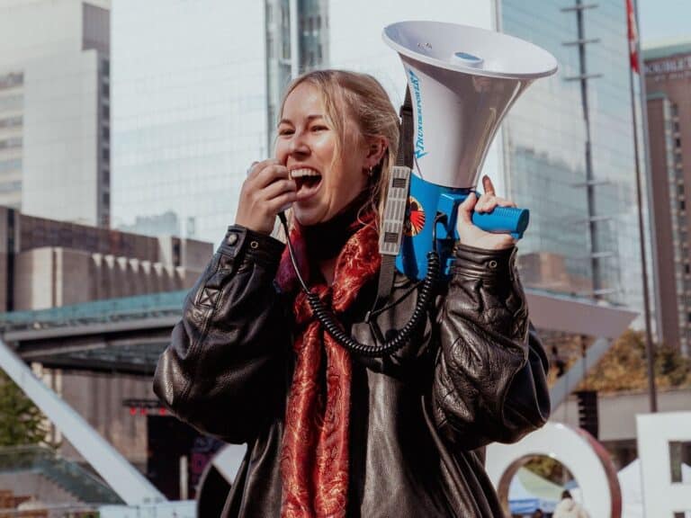 A woman speaks into a megaphone