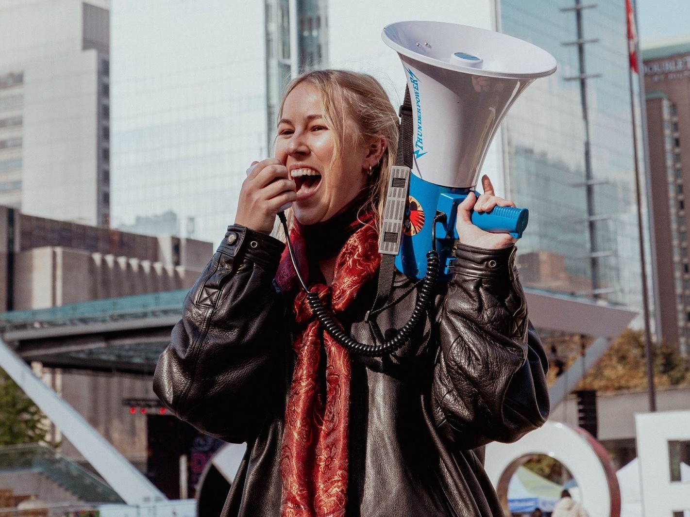 A woman speaks into a megaphone
