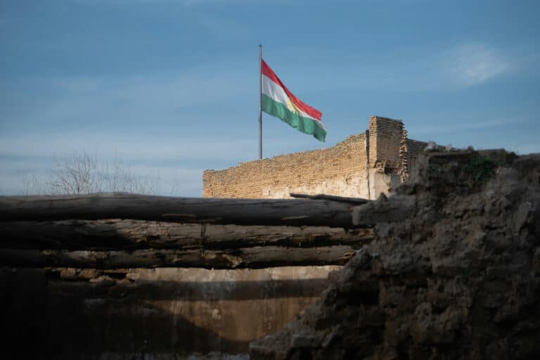 flag flies over building in sunlight