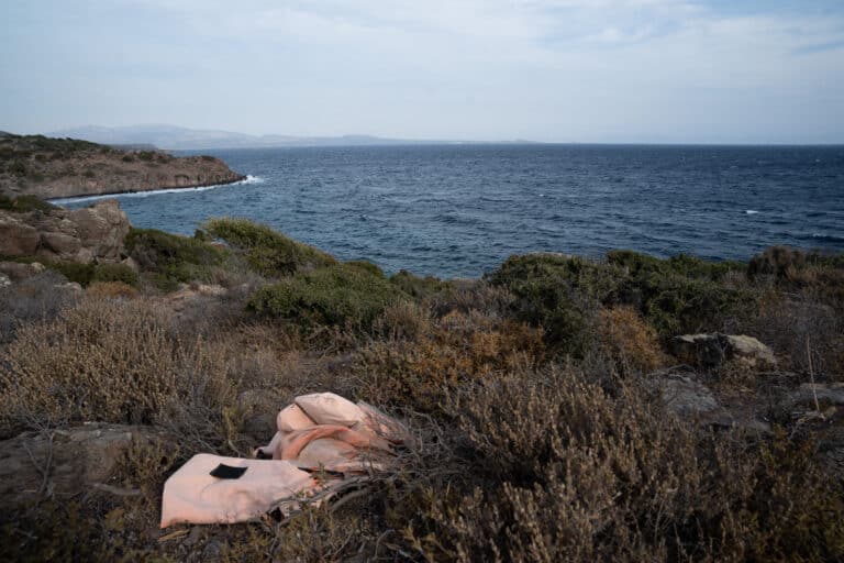 A faded orange life jacket on the lesvos coast