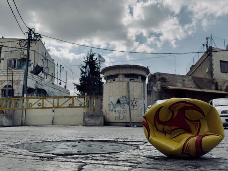 A deflated football in front of a checkpoint