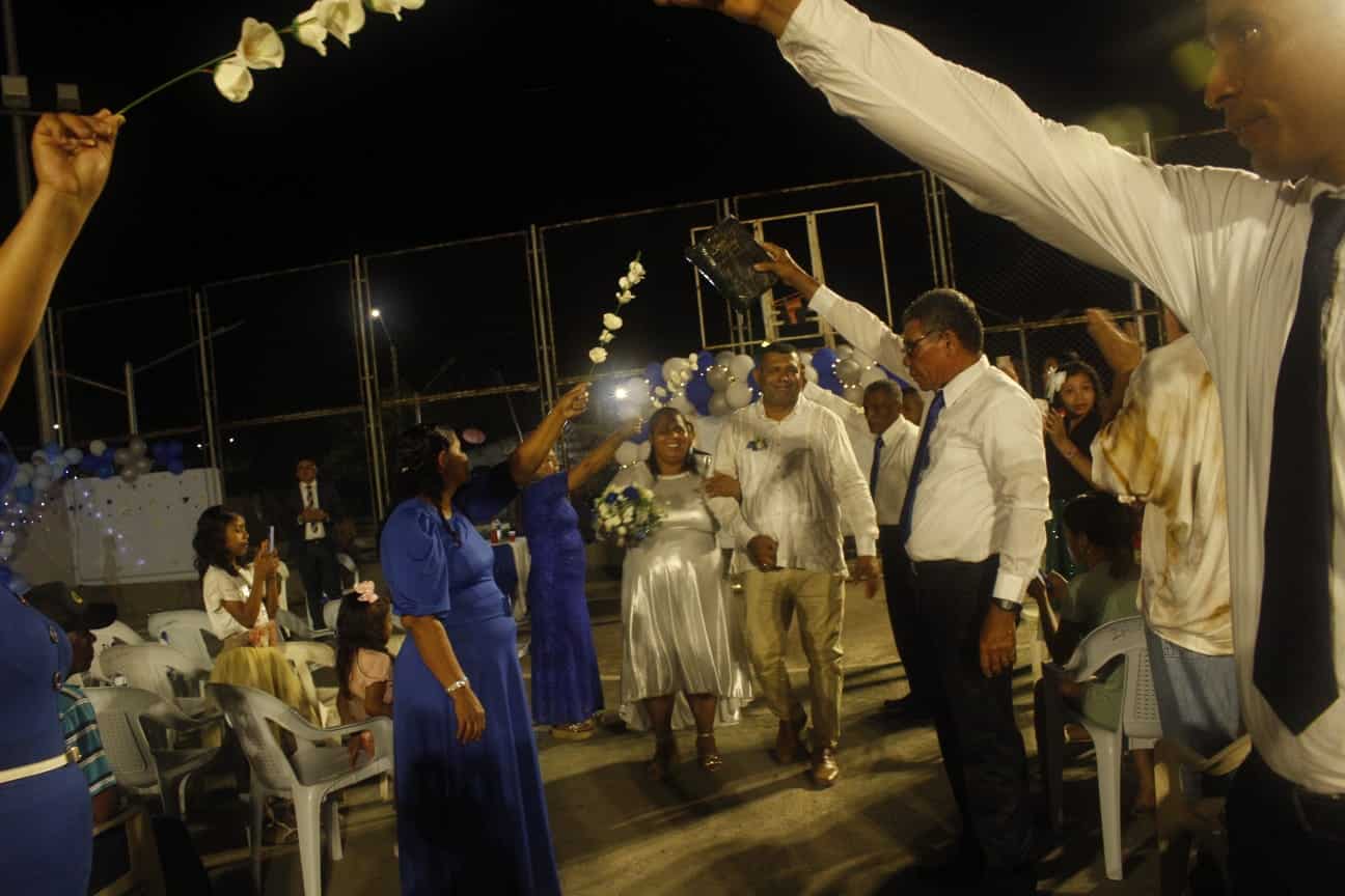 a married couple walked in a tunnel formed of arms of people around