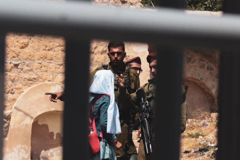 soldiers question a school girl in palestine