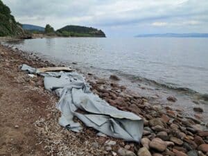 A destroyed dinghy on a beach