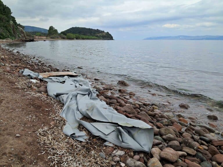 A destroyed dinghy on a beach
