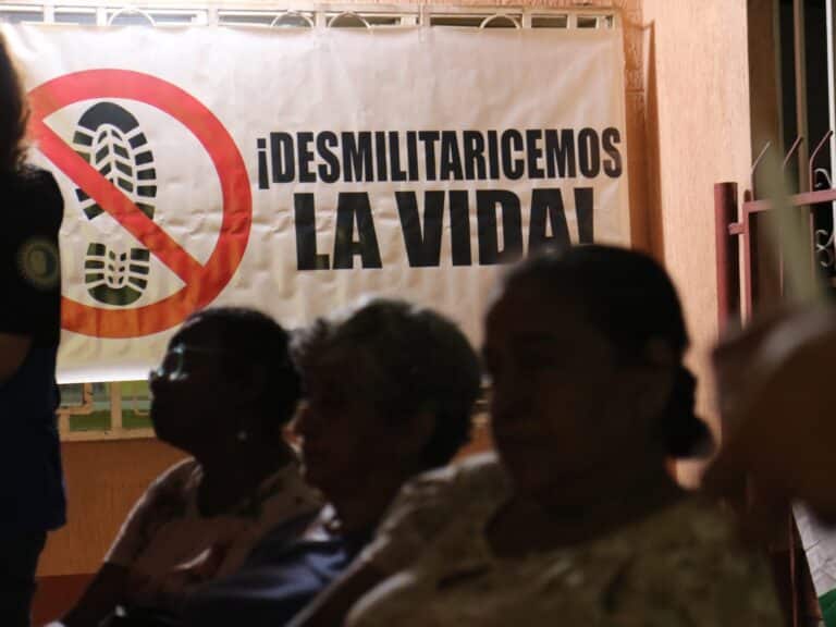 A banner reading "demilitarize life"