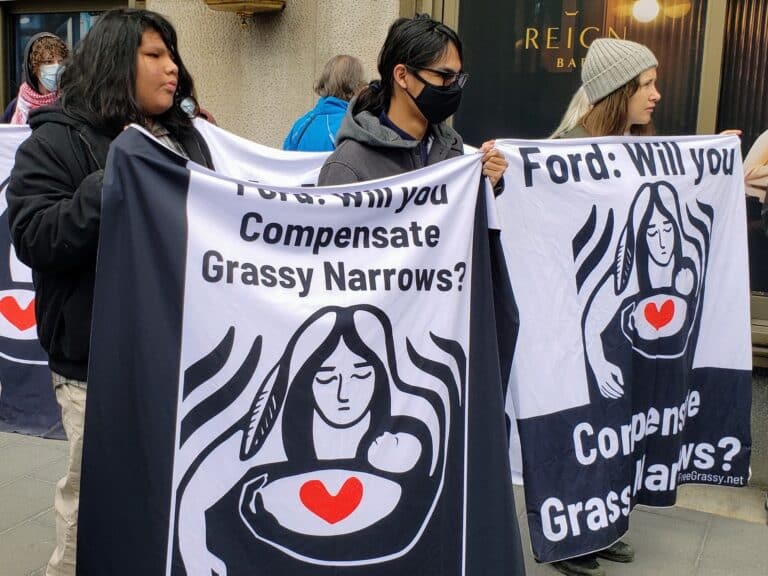 People holding Grassy Narrows banners