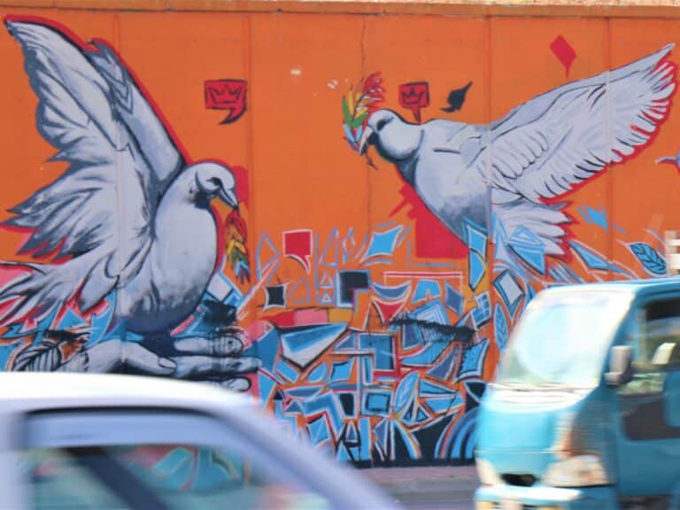 A mural on a wall of two doves