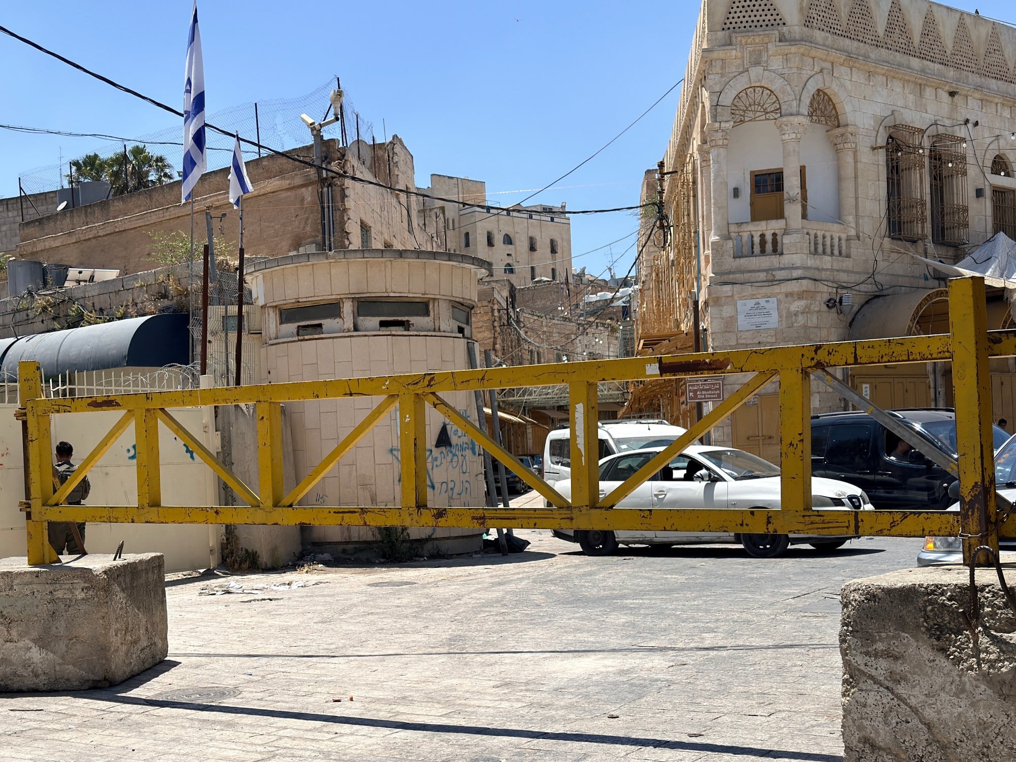 A metal gate blocking a road
