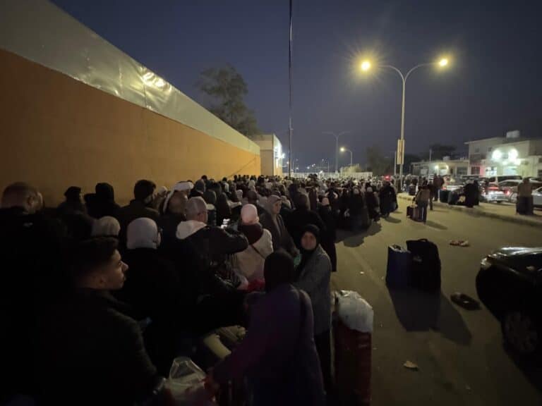 A crowd waiting at a border