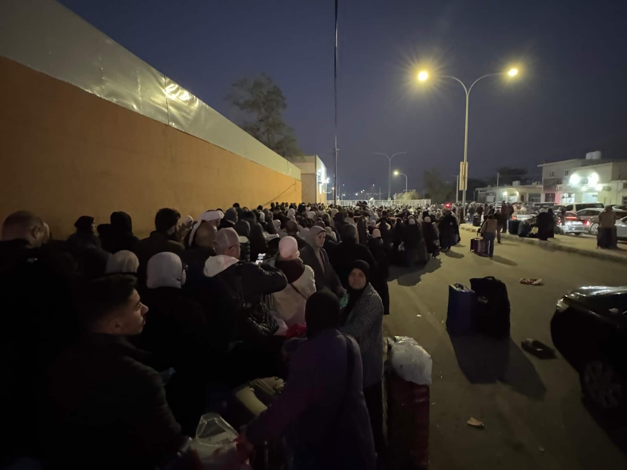 A crowd waiting at a border