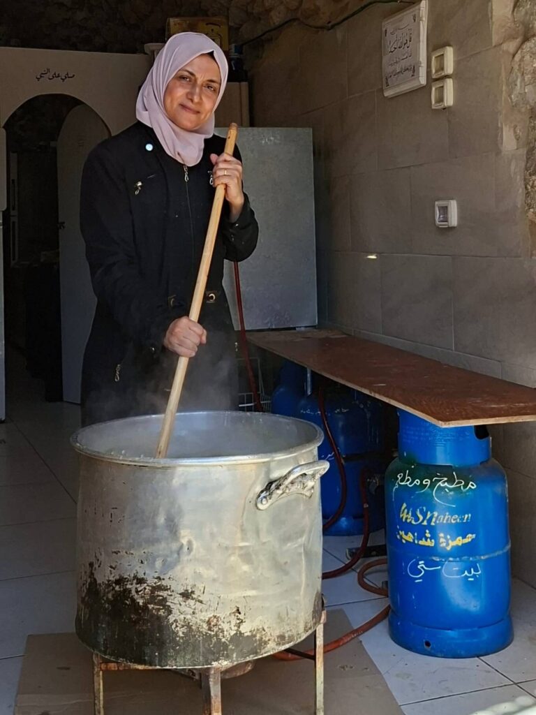 A woman stirring a cooking pot