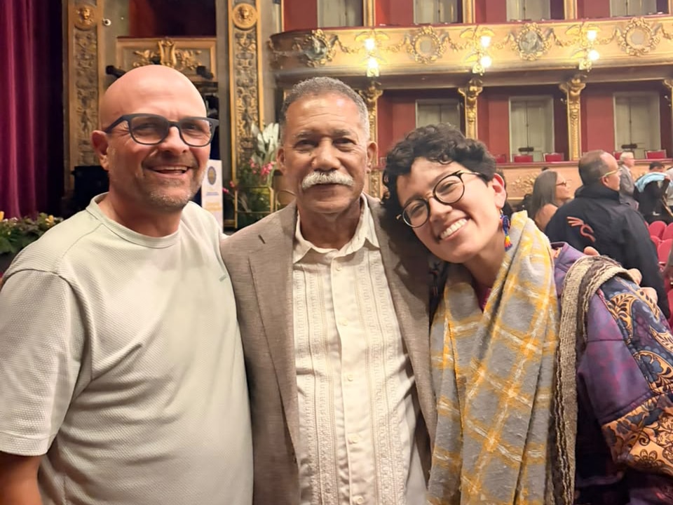 Three people smiling for a photograph