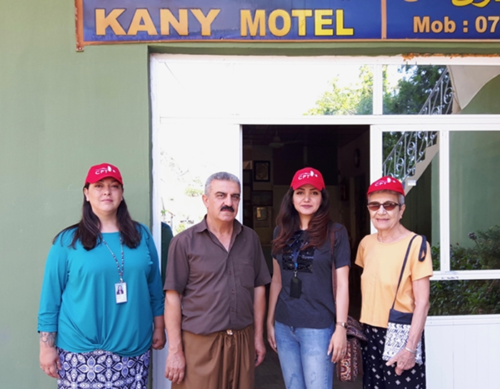 Ayub with the CPT team outside of his motel and tahini factory.